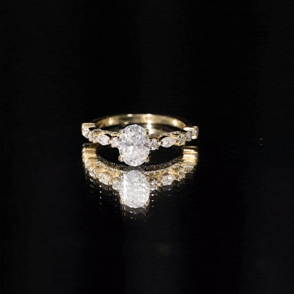 gold solitaire engagement ring featuring a Carat IGI Certified Oval Diamond center stone with marquise and round side stones