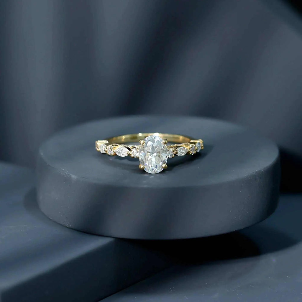 Gold solitaire engagement ring with Carat IGI Certified Oval Diamond center stone and marquise cut side diamonds