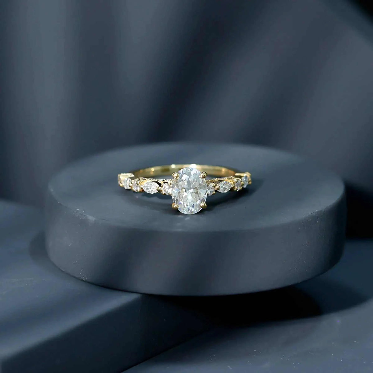 Gold solitaire engagement ring with Carat IGI Certified Oval Diamond center stone and marquise cut side diamonds