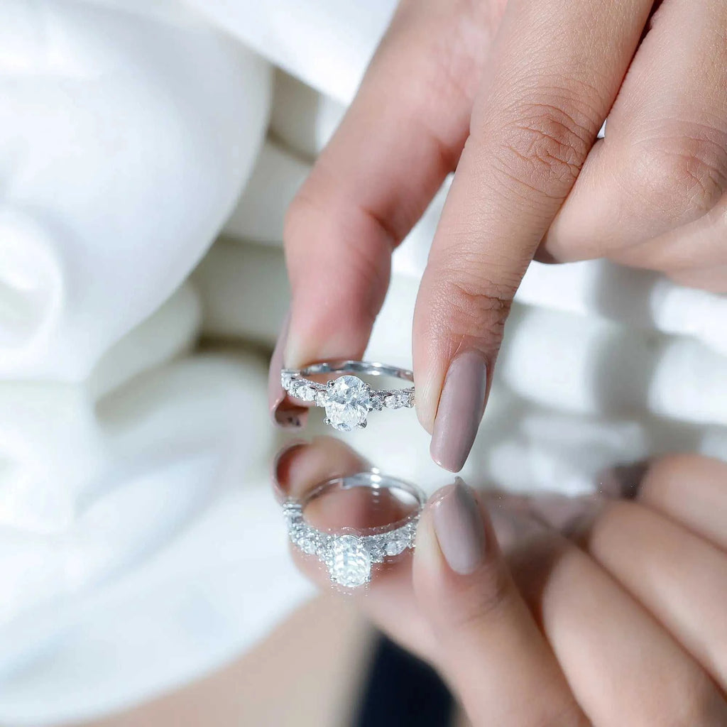 Carat IGI Certified Oval Diamond solitaire engagement ring in white gold with a central oval diamond and side stones on the band