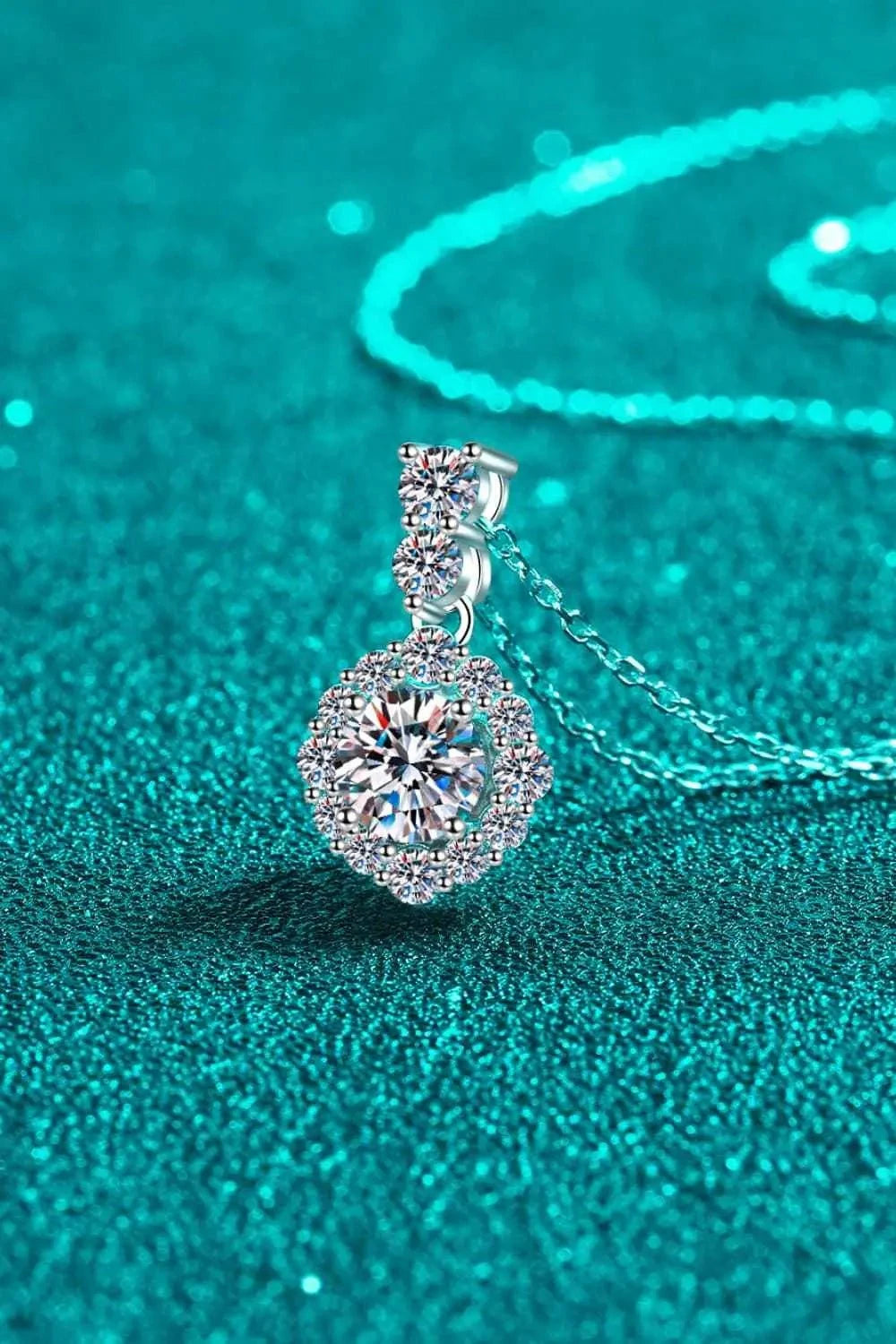 925 sterling silver necklace with a Carat Moissanite center stone surrounded by zircon accent stones on a fine chain