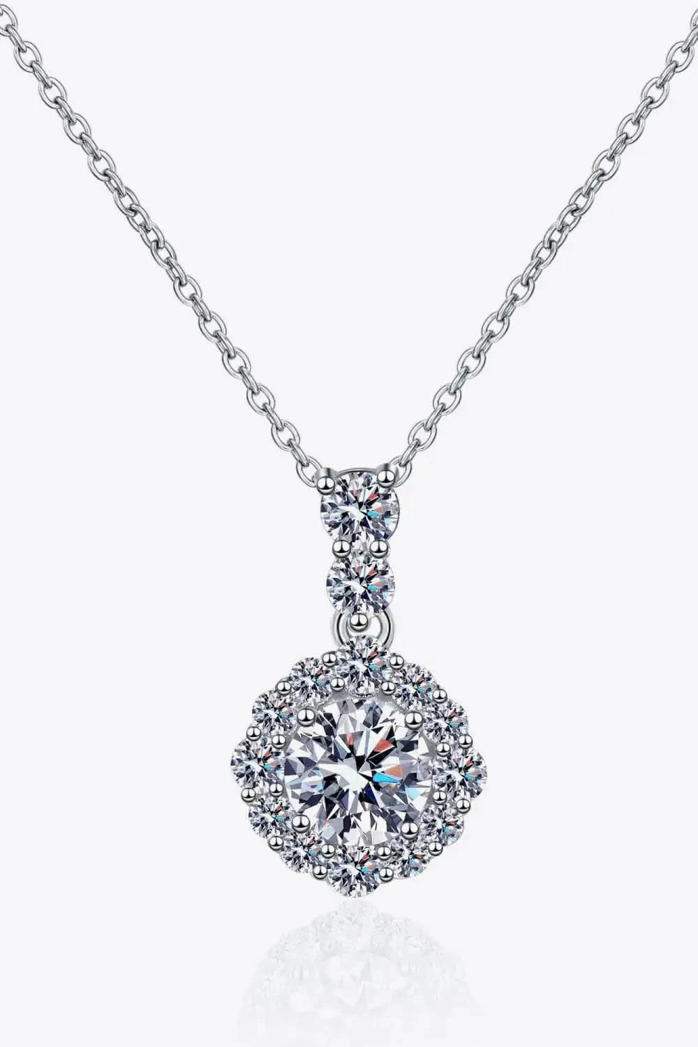 925 sterling silver necklace with a round center Carat Moissanite gemstone surrounded by smaller accent stones on a delicate chain