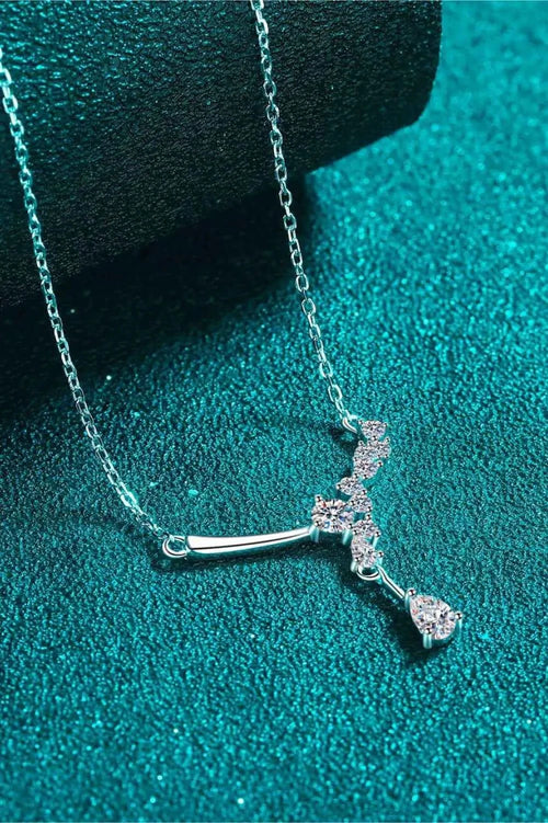925 sterling silver necklace with a delicate chain and sparkling Carat Moissanite stones arranged in a cross pendant design