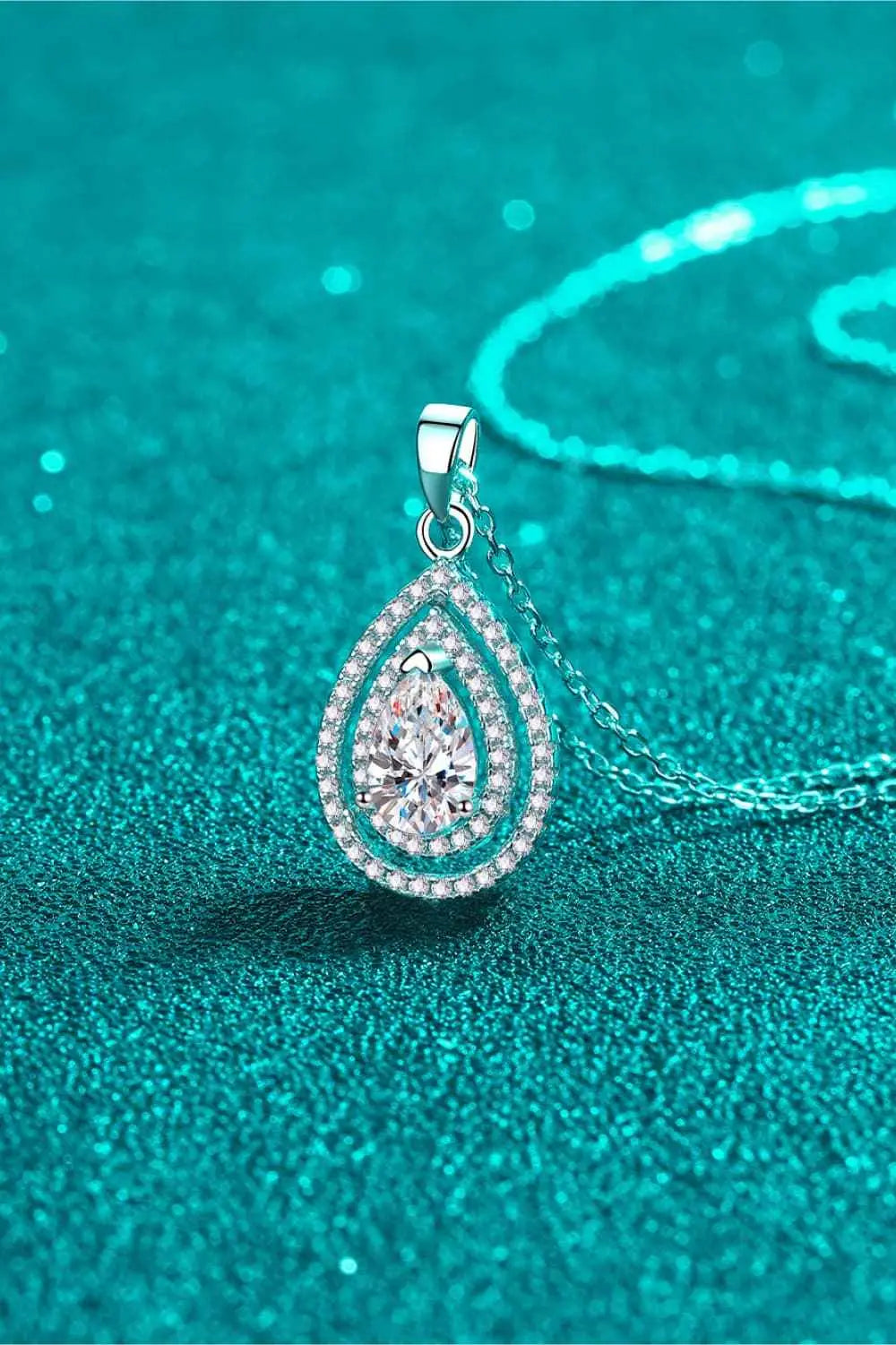 Carat Moissanite Teardrop Pendant with 1 carat teardrop-shaped center stone surrounded by smaller stones on sterling silver chain