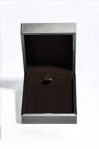 Empty grey and black jewelry box with a dark velvet interior and a small holder for a pendant