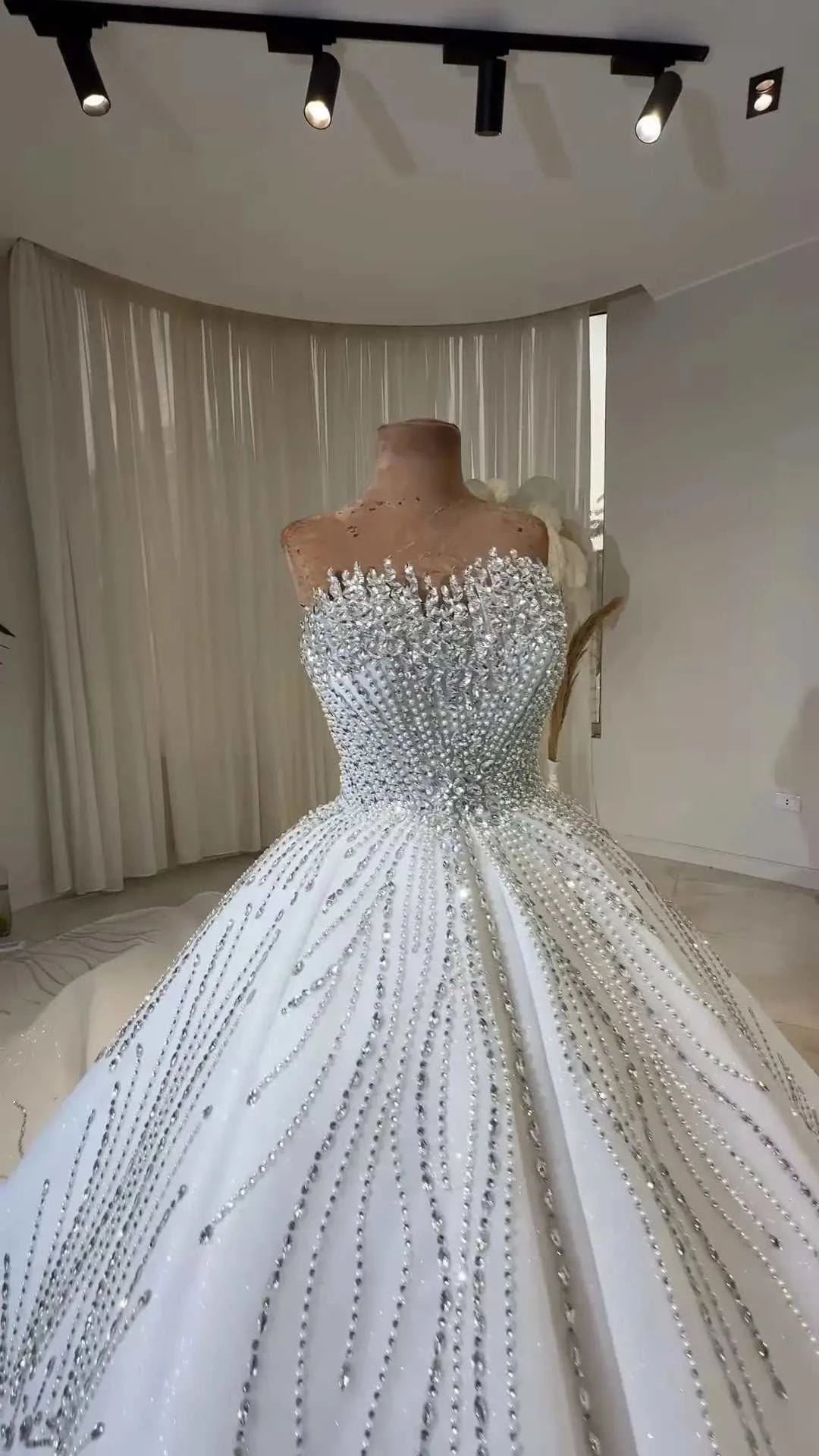 Celeste Crystal Ball Gown white ball gown wedding dress adorned with intricate crystal beadwork and fitted bodice
