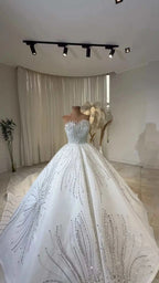 Celeste Crystal Ball Gown white ball gown bridal dress with off the shoulder neckline, intricate beading, and pleated lace details