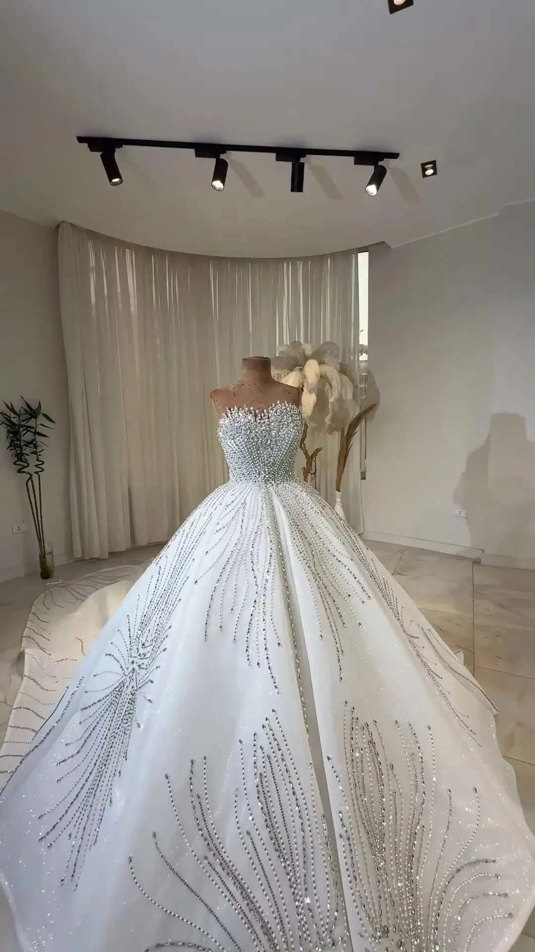 Celeste Crystal Ball Gown white ball gown bridal dress with off the shoulder neckline, intricate beading, and pleated lace details