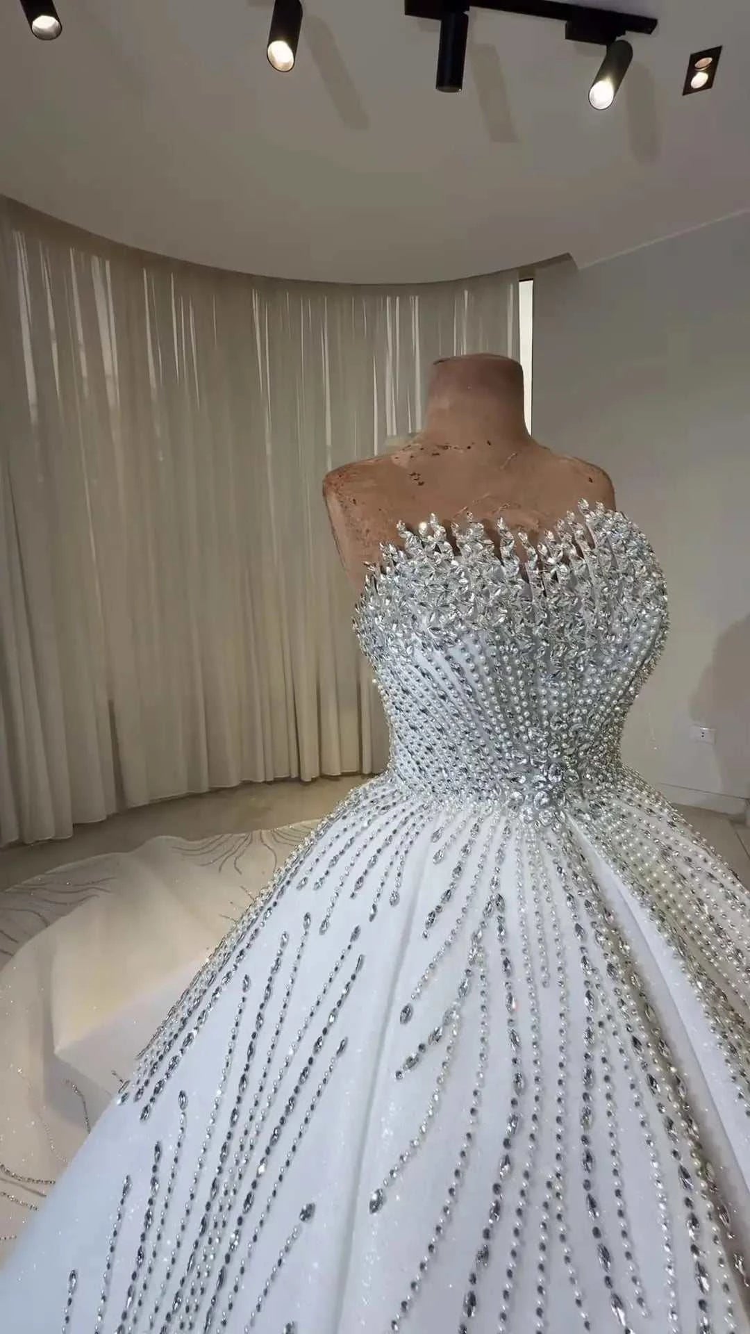 Celeste Crystal Ball Gown white strapless bridal dress with intricate beading and crystal embellishments on bodice and skirt