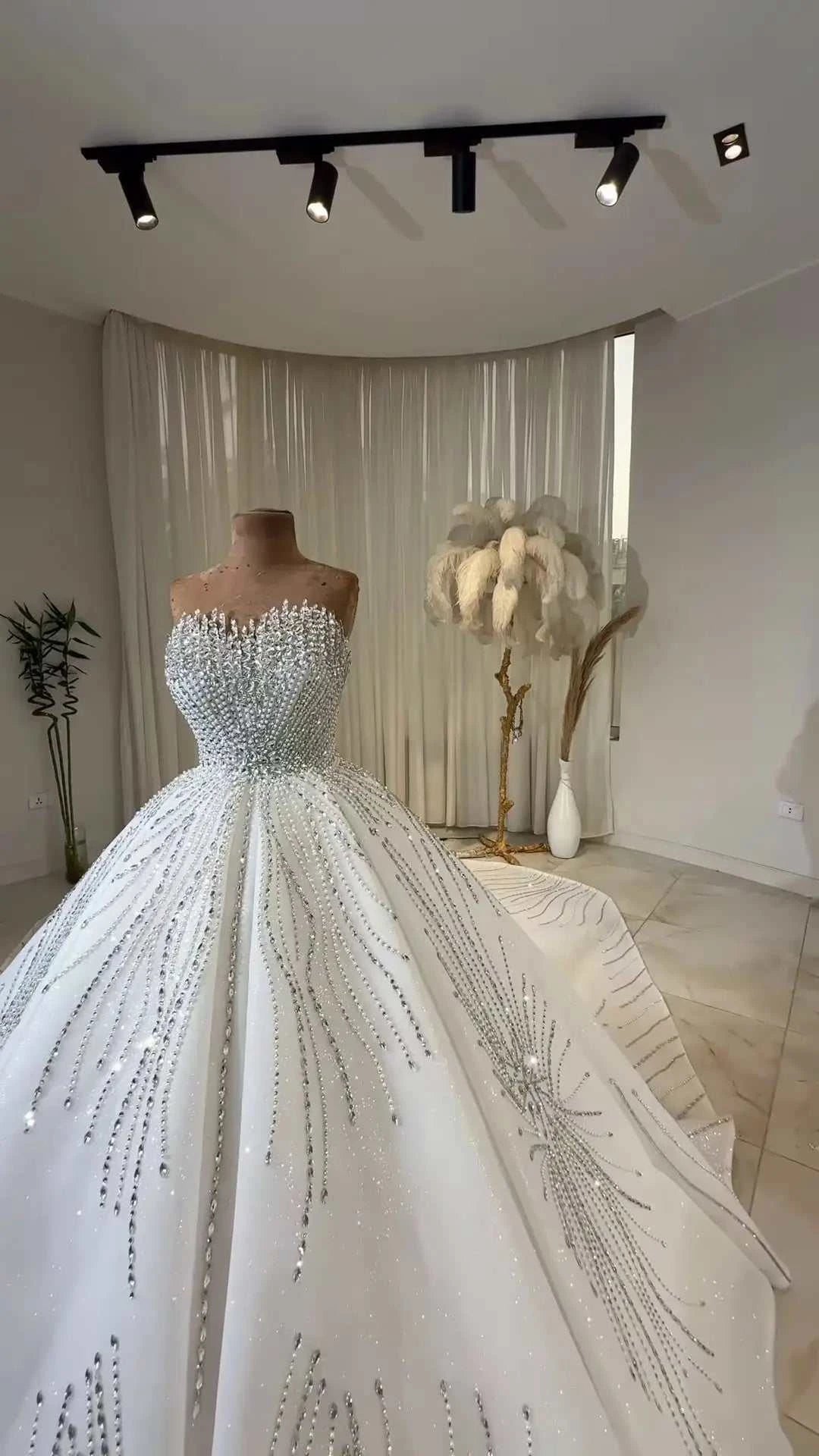 Celeste Crystal Ball Gown featuring intricate silver beading and lace on a voluminous white tulle skirt with off-the-shoulder neckline