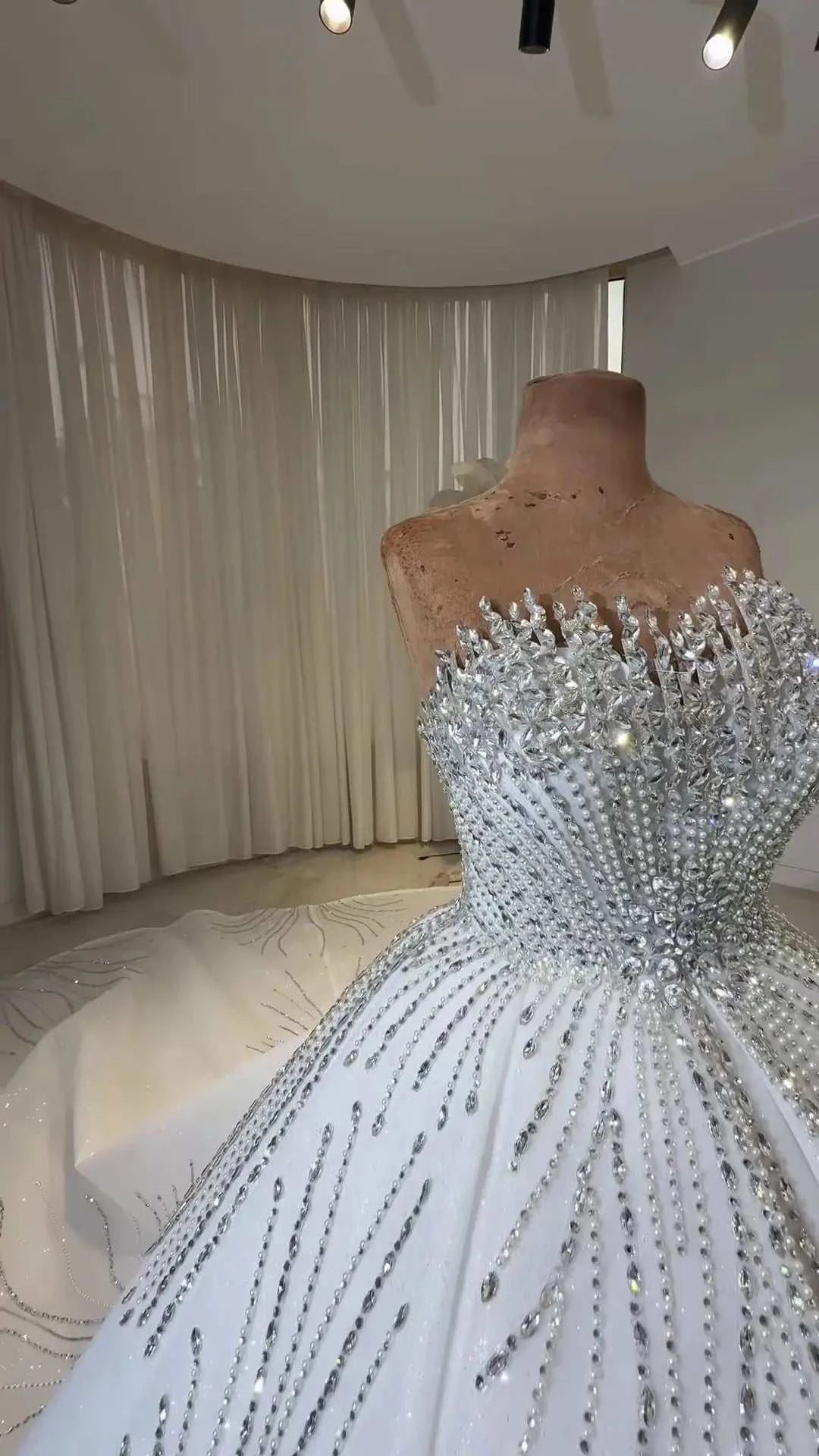 Celeste Crystal Ball Gown white ball gown with intricate beadwork and crystal embellishments on the bodice and skirt