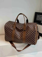 Large checkered pattern travel bag in brown PU leather with dark brown handles and adjustable shoulder strap