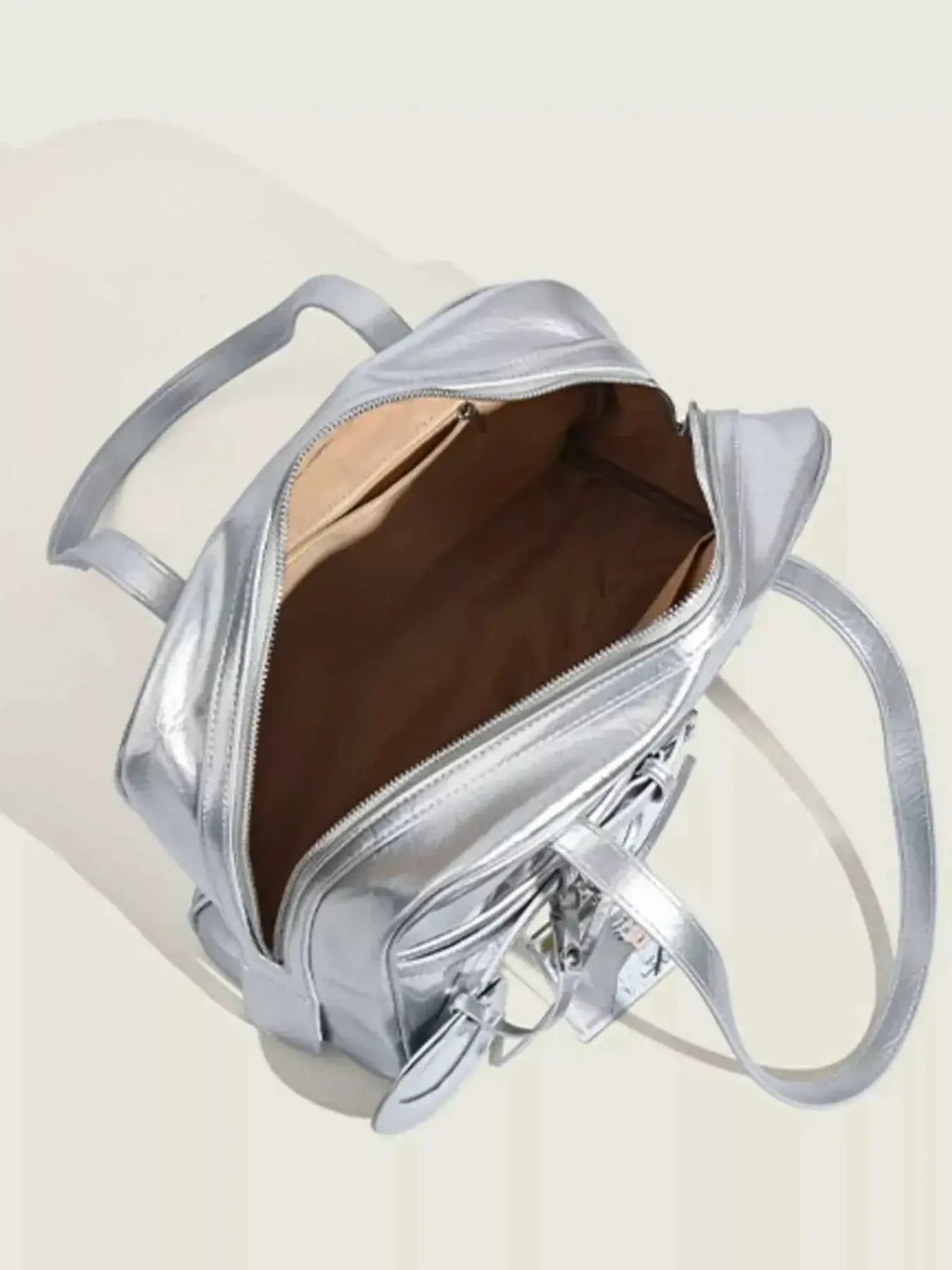 Clear Window Shoulder Bag in metallic silver PU leather with a zipper, double handles, and an open interior compartment.