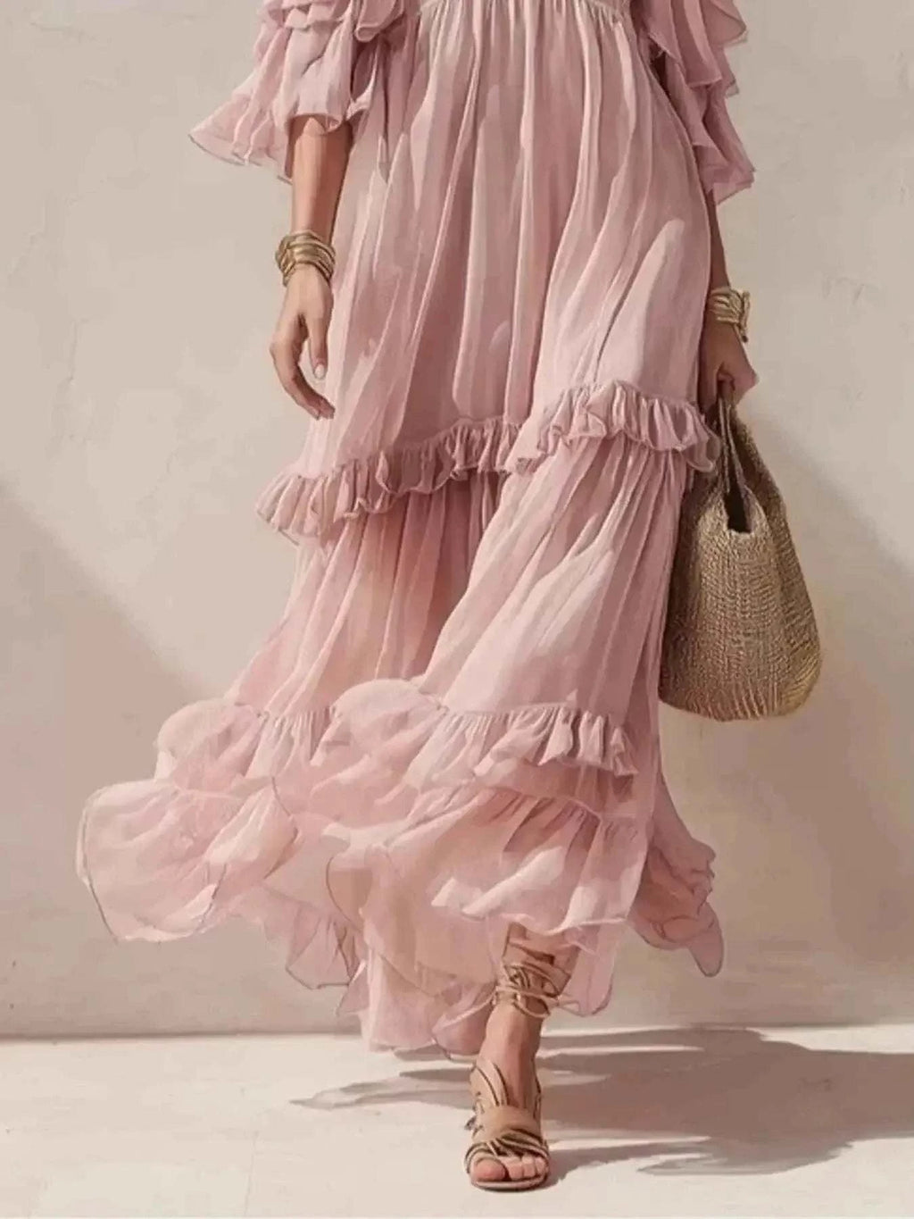 Cold-Shoulder Ruffled Maxi Dress in soft pink chiffon with tiered ruffles and flowing maxi length for elegant movement.