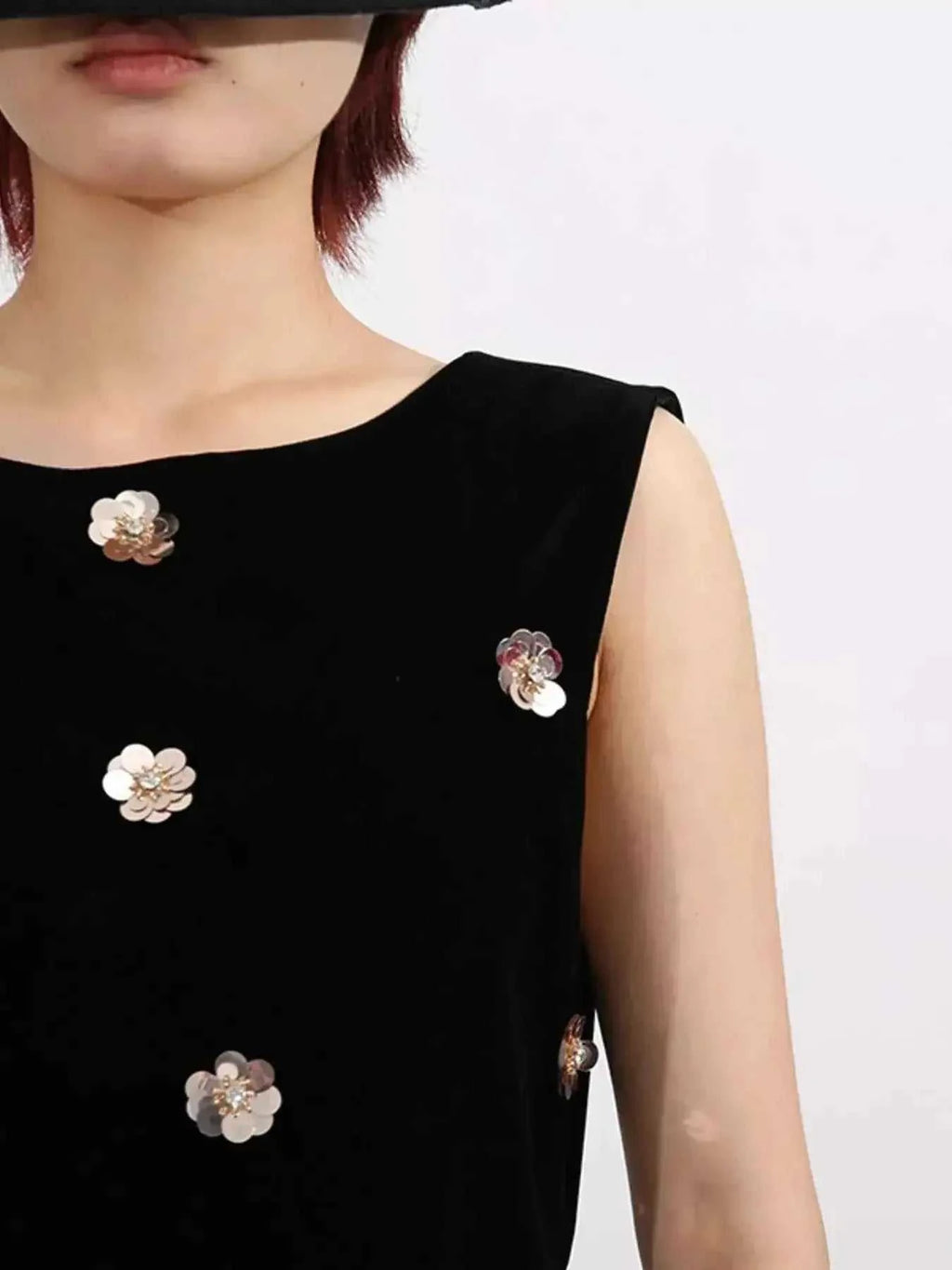 Contrast Flower Sleeveless black velvet dress with sleeveless design and metallic floral embellishments on front