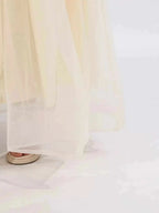 Contrast Flower Sleeveless sheer ivory tulle maxi dress hem with visible lining and layered fabric detail