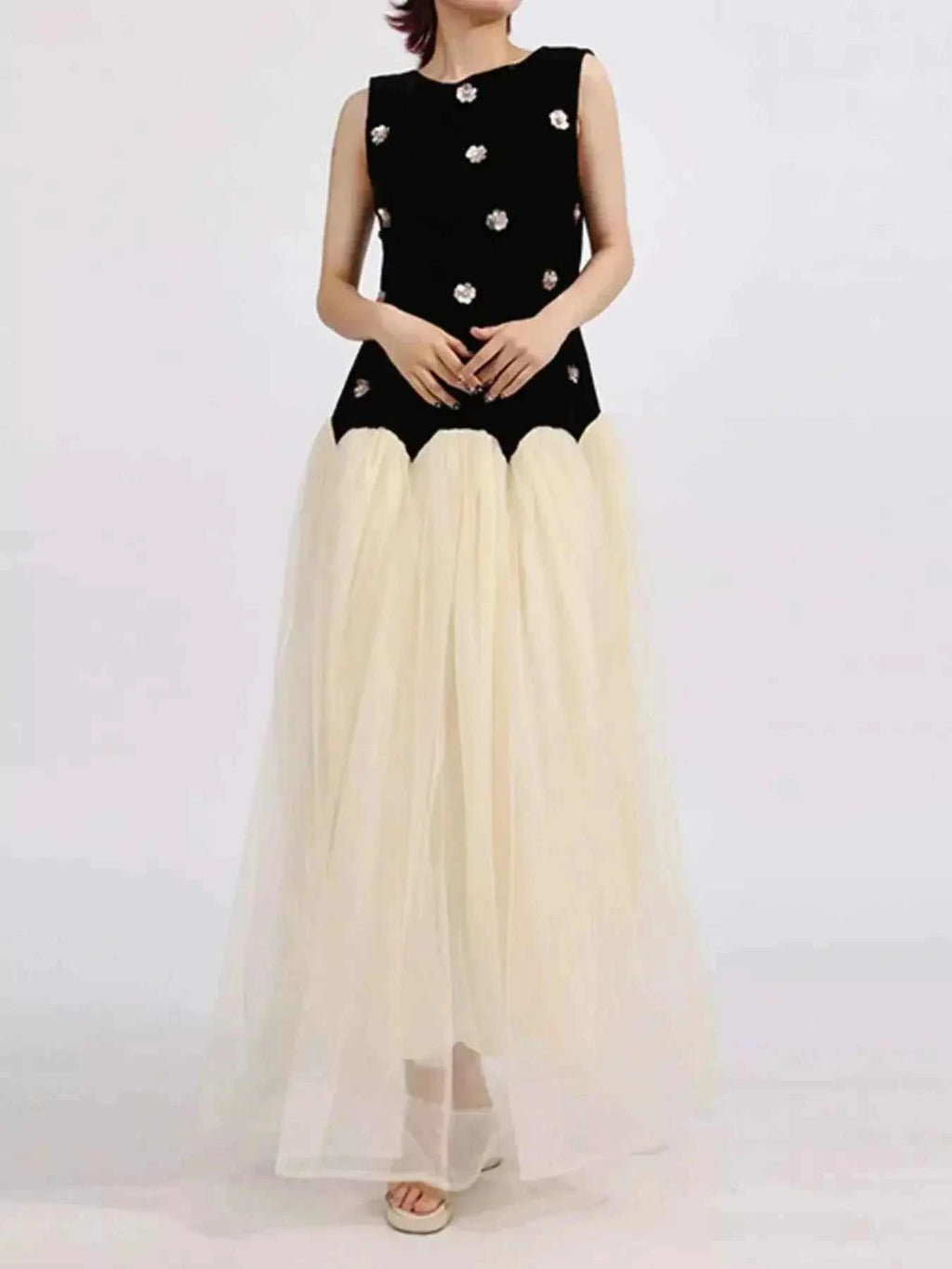 Contrast Flower Sleeveless tulle maxi dress with a black sleeveless top adorned with floral appliques and a flowing cream tulle skirt