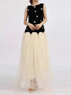 Contrast Flower Sleeveless tulle maxi dress with a black sleeveless top adorned with floral appliques and a flowing cream tulle skirt