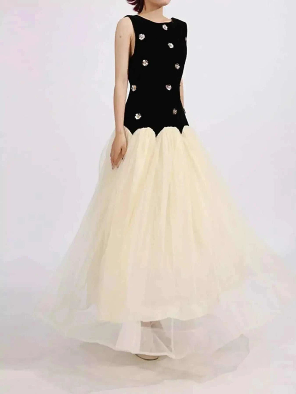 Contrast Flower Sleeveless tulle maxi dress with black ruched bodice and white flowing skirt embellished with floral appliques