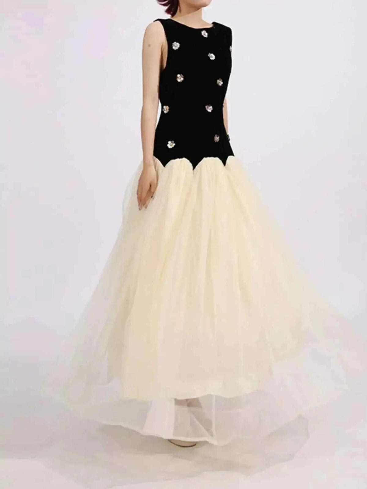 Contrast Flower Sleeveless tulle maxi dress with black ruched bodice and white flowing skirt embellished with floral appliques