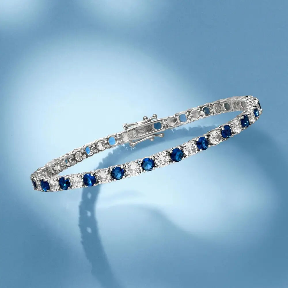 Created White & Blue Sapphire tennis bracelet featuring alternating round white and blue sapphires in polished silver-tone metal with a box clasp