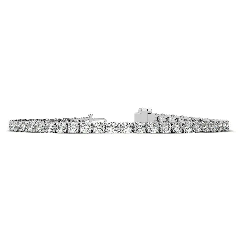 Created White Sapphire tennis bracelet with 3mm round stones set in 14K white gold overlay featuring secure clasp