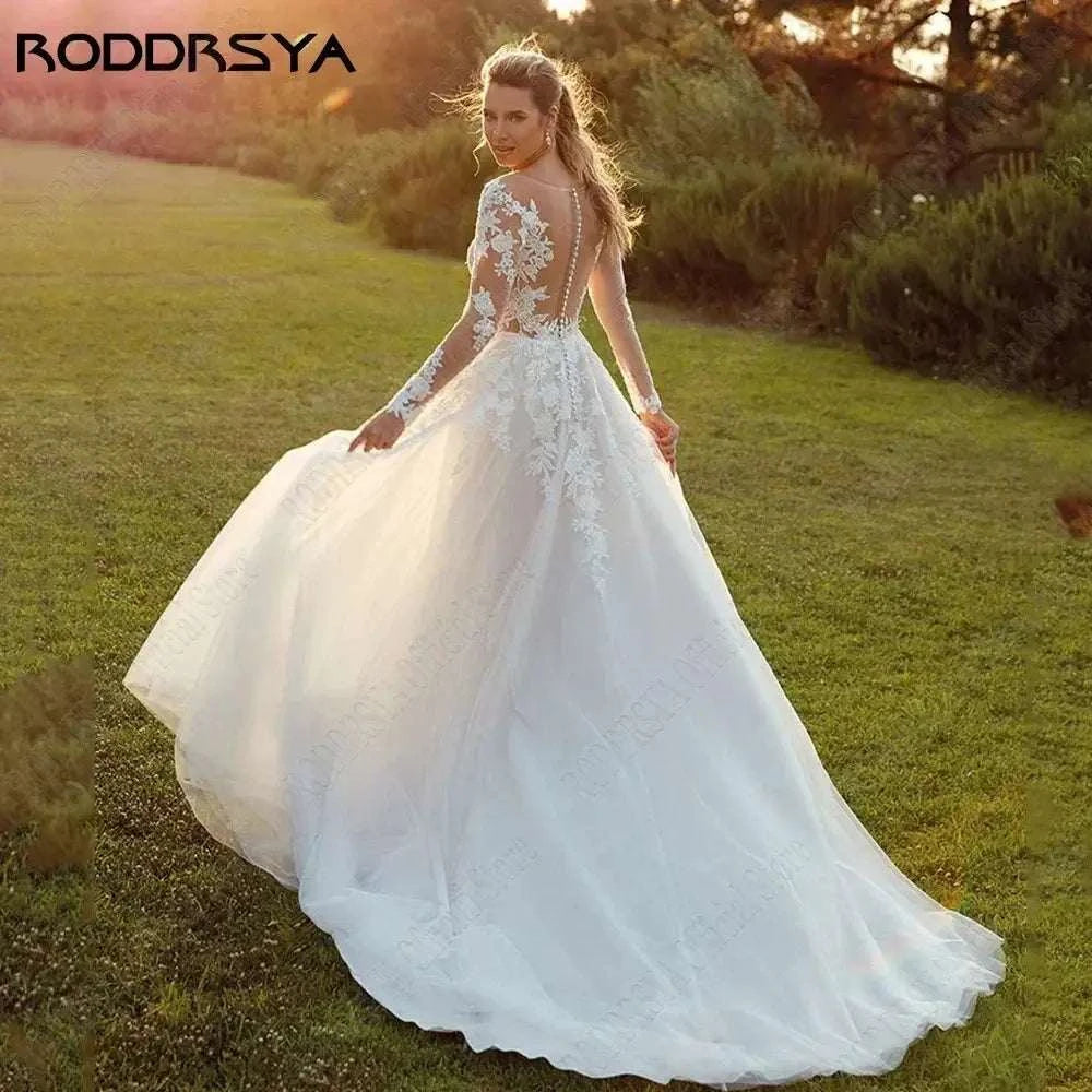 Customized Wedding Dress featuring a white tulle A-line gown with long illusion lace sleeves and a scoop illusion back with appliques