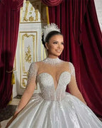 White Customized Wedding Dresses ball gown with long sheer sleeves, high neck, and pearl embellishments with crown