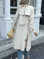 Double-Breasted Belted Trench Coat in light beige polyester with a belt at the waist and buttoned cuffs shown from back