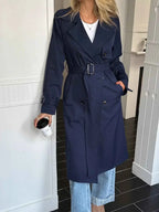 Double-Breasted Belted Trench Coat in dark navy polyester with buttoned front, wide lapels, and belted waist worn with light blue jeans