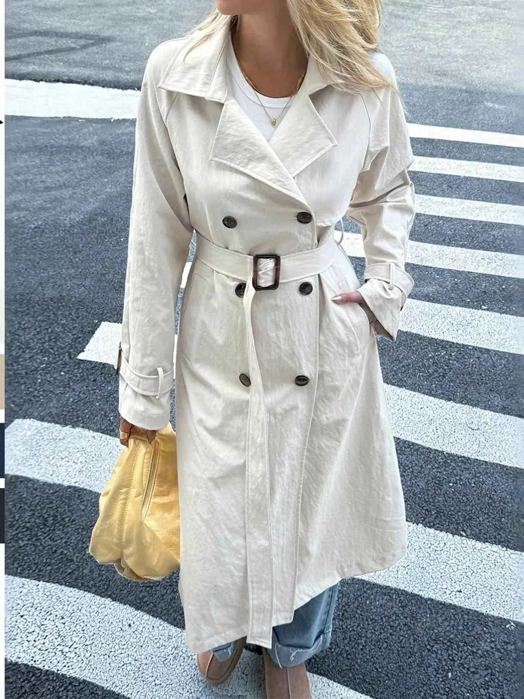 Double-Breasted Belted Trench Coat in light beige polyester with buttoned front, belted waist, and wide lapel collar