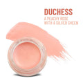 Peachy rose waterproof multi-tasking creme-to-powder product with silver sheen in clear glass jar for lip color and more