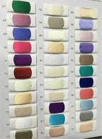 Fabric swatches in various solid pastel and bright colors arranged in three vertical columns for wedding dress customization