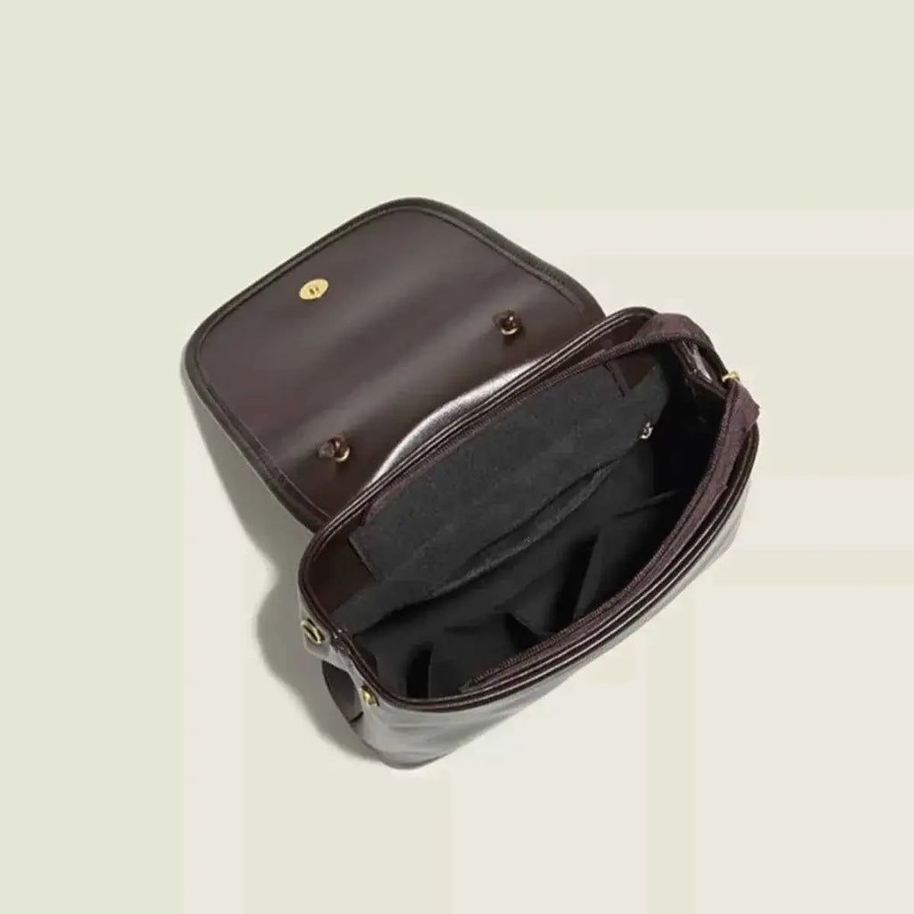 Mini flap backpack bag in dark brown corduroy material with a flap closure and beaded handle detail