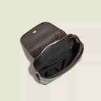 Mini flap backpack bag in dark brown corduroy material with a flap closure and beaded handle detail