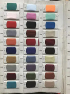 Swatches of assorted fabric colors on a white card used for Flavinke Wedding Dresses customization, including blues, reds, greens, and neutrals