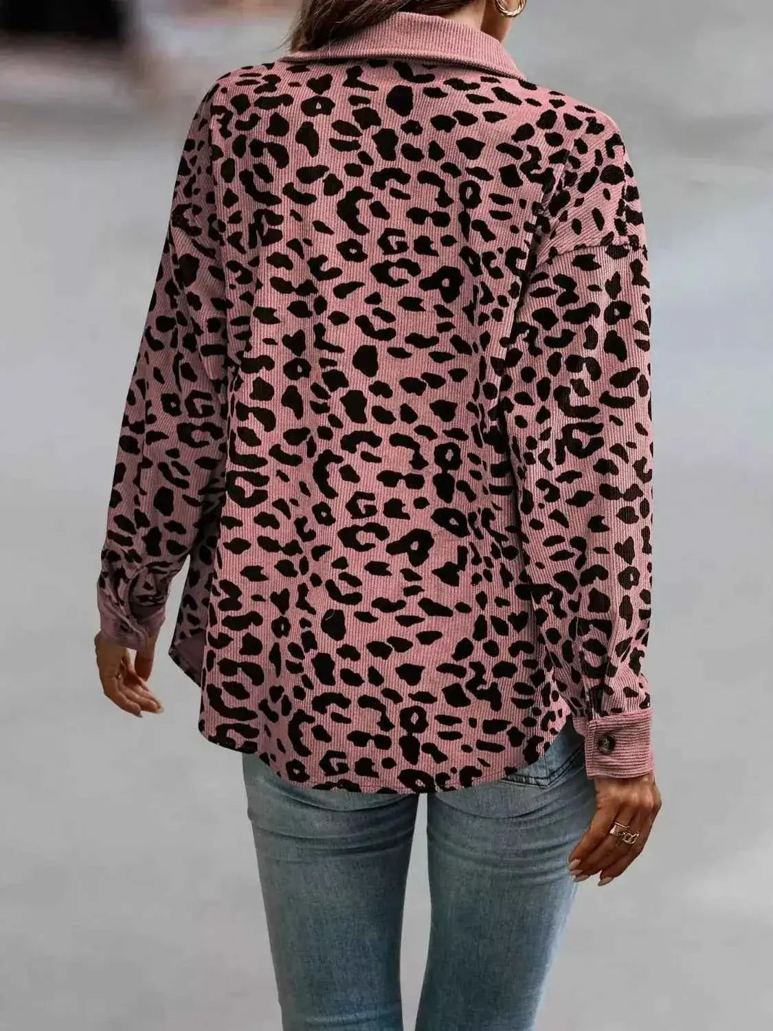 Full Size Leopard Print button-down jacket in pink and black with long sleeves and a relaxed fit, worn with jeans