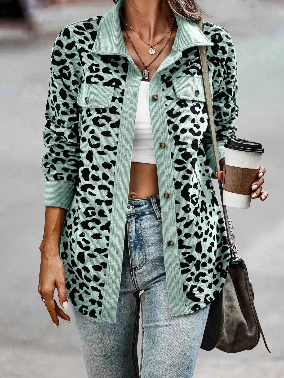 Full Size Leopard Print button-down jacket in muted green with black spots, long sleeves, and chest pockets worn with casual denim jeans