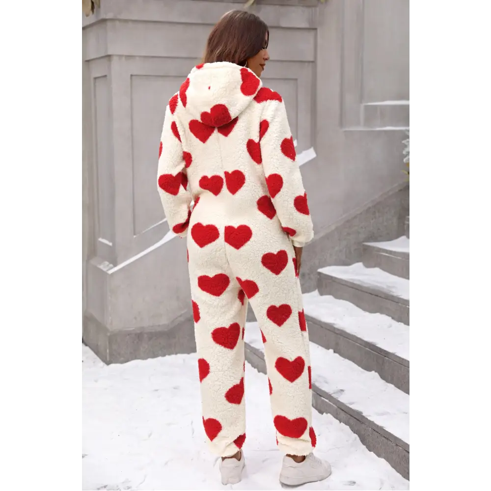 Elevate your wardrobe with the fuzzy heart zip up hooded lounge jumpsuit $35.99 this exquisite piece embodies a basic