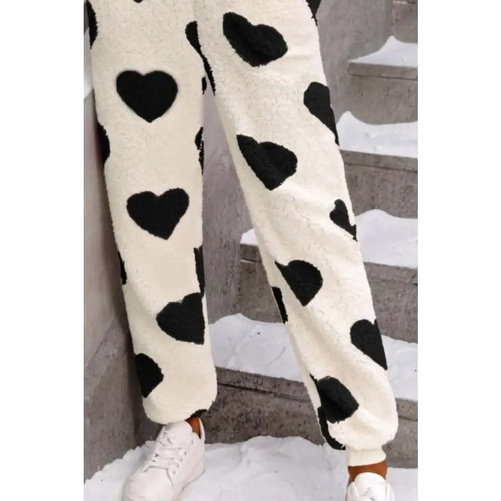 Elevate your wardrobe with the fuzzy heart zip up hooded lounge jumpsuit $35.99 this exquisite piece embodies a basic