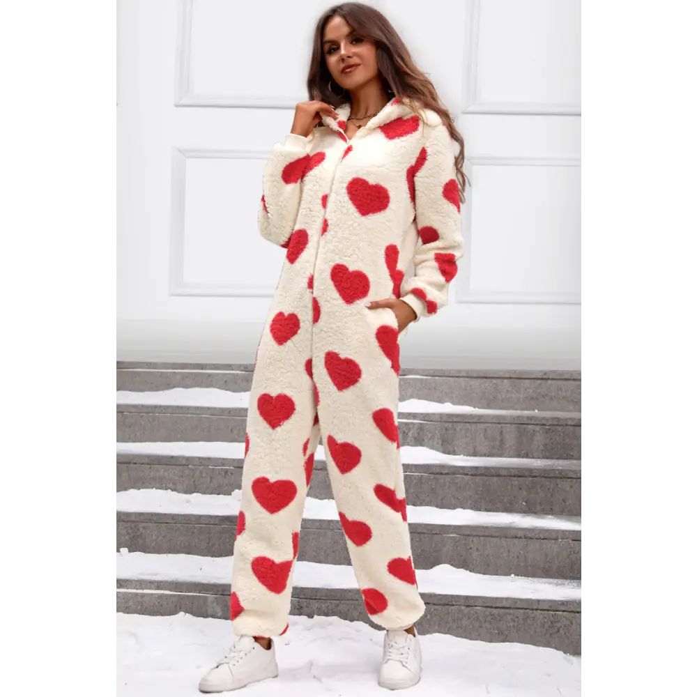 Elevate your wardrobe with the fuzzy heart zip up hooded lounge jumpsuit $35.99 this exquisite piece embodies a basic