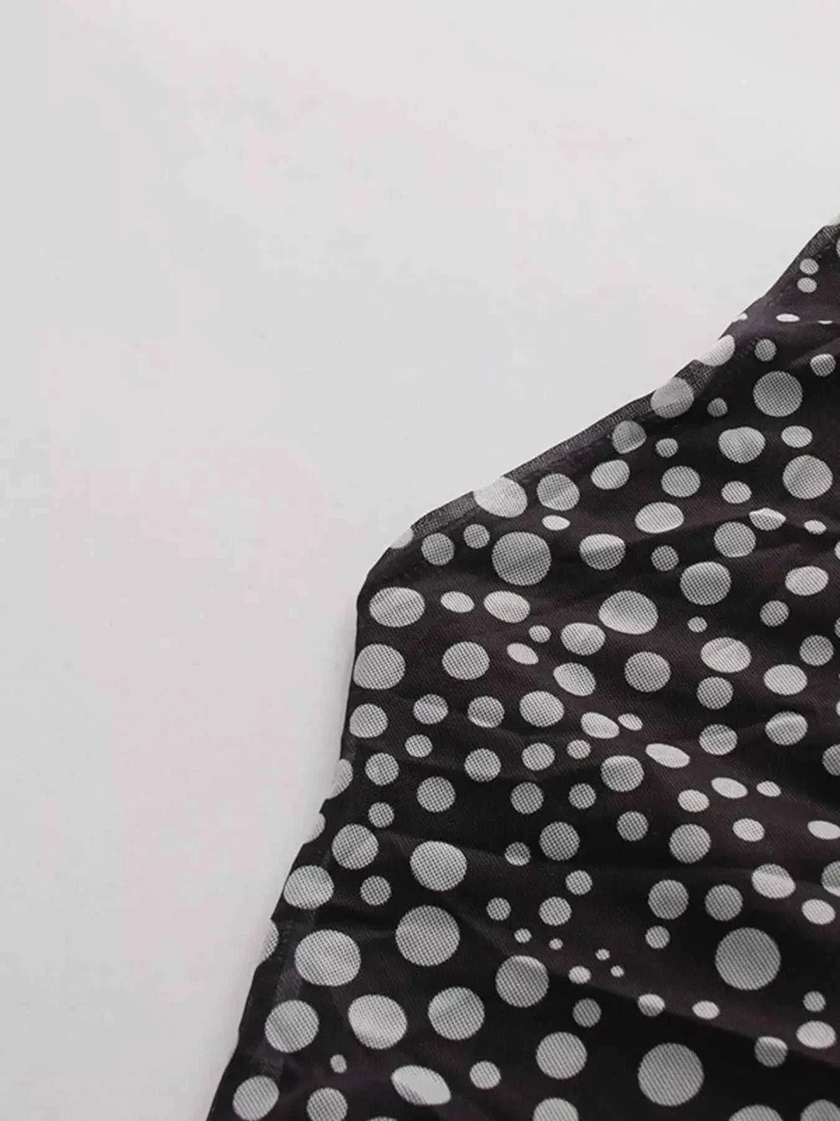 Halter Neck Polka Dot black fabric with white polka dots, slightly stretchy polyester, tied feature visible