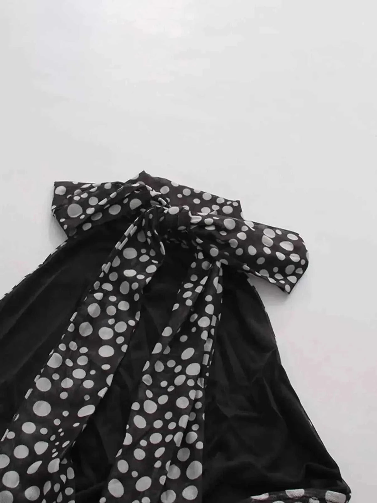 Halter Neck Polka Dot black dress with white polka dots, tied halter neck, and flowy fabric