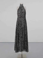 Halter Neck Polka Dot maxi dress in black with white polka dots, halter neck tie, and flowy full-length skirt