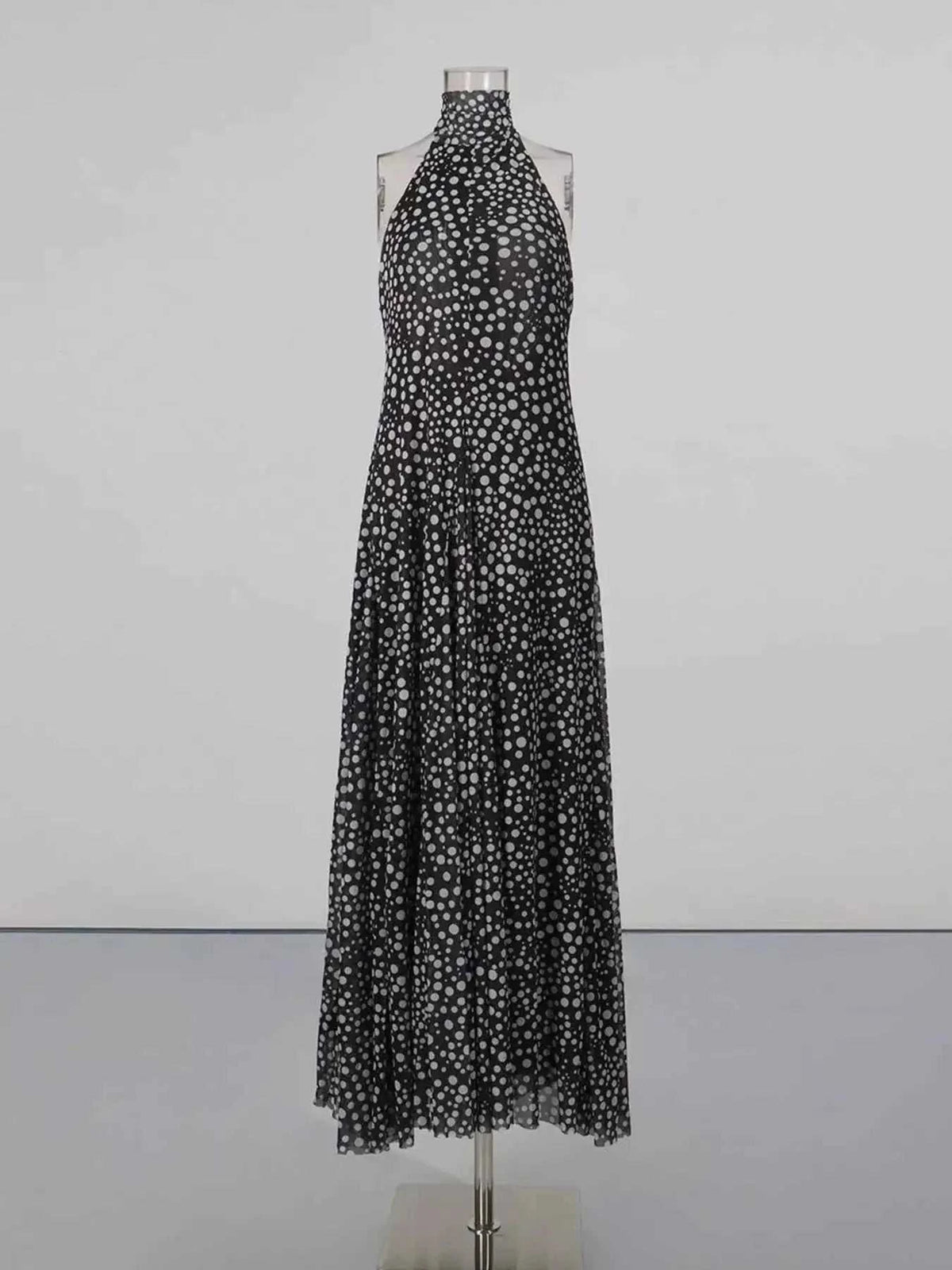 Halter Neck Polka Dot maxi dress in black with white polka dots, halter neck tie, and flowy full-length skirt