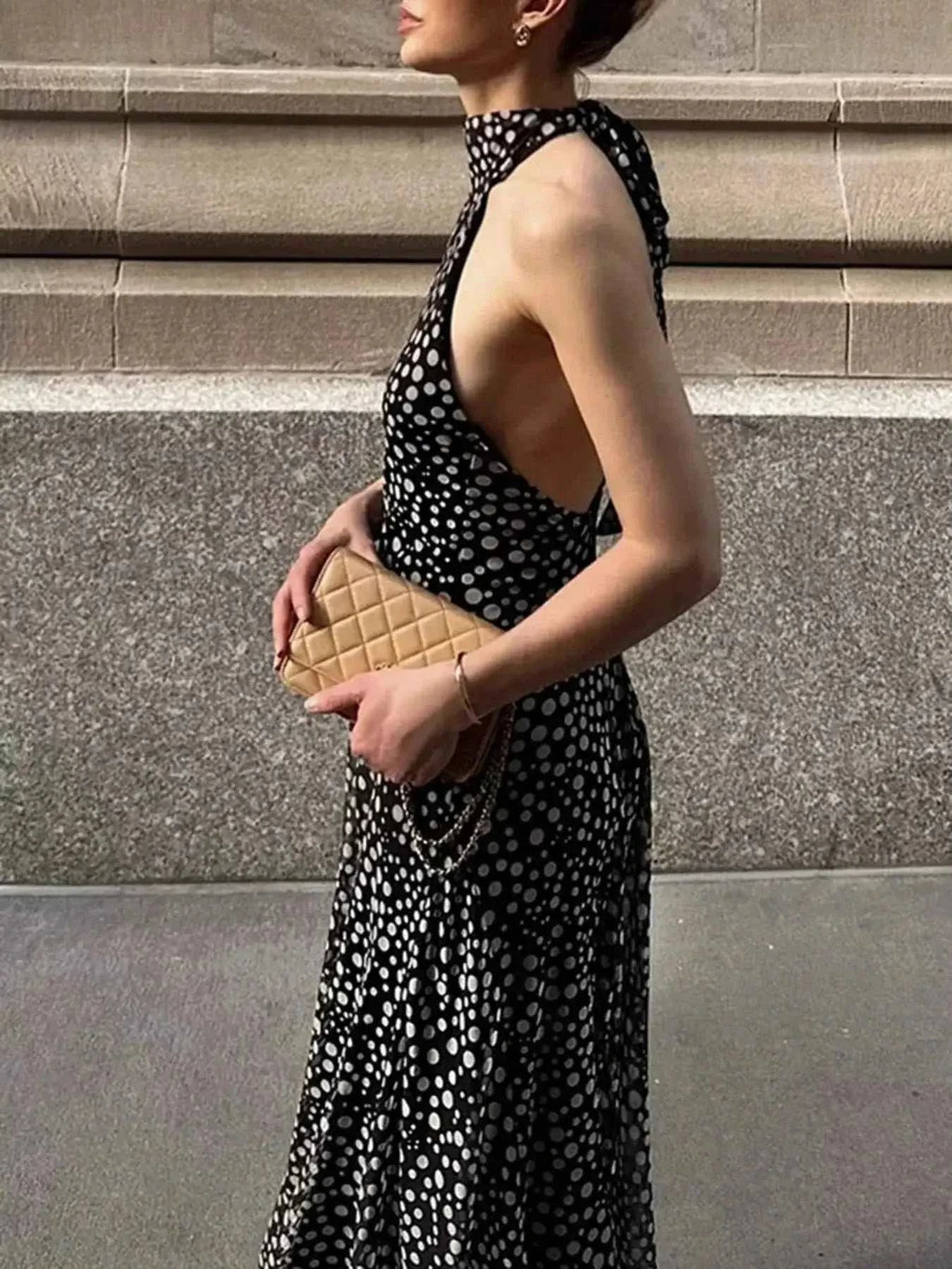 Halter Neck Polka Dot maxi dress in black with white polka dots, tied halter neck, and sleeveless design