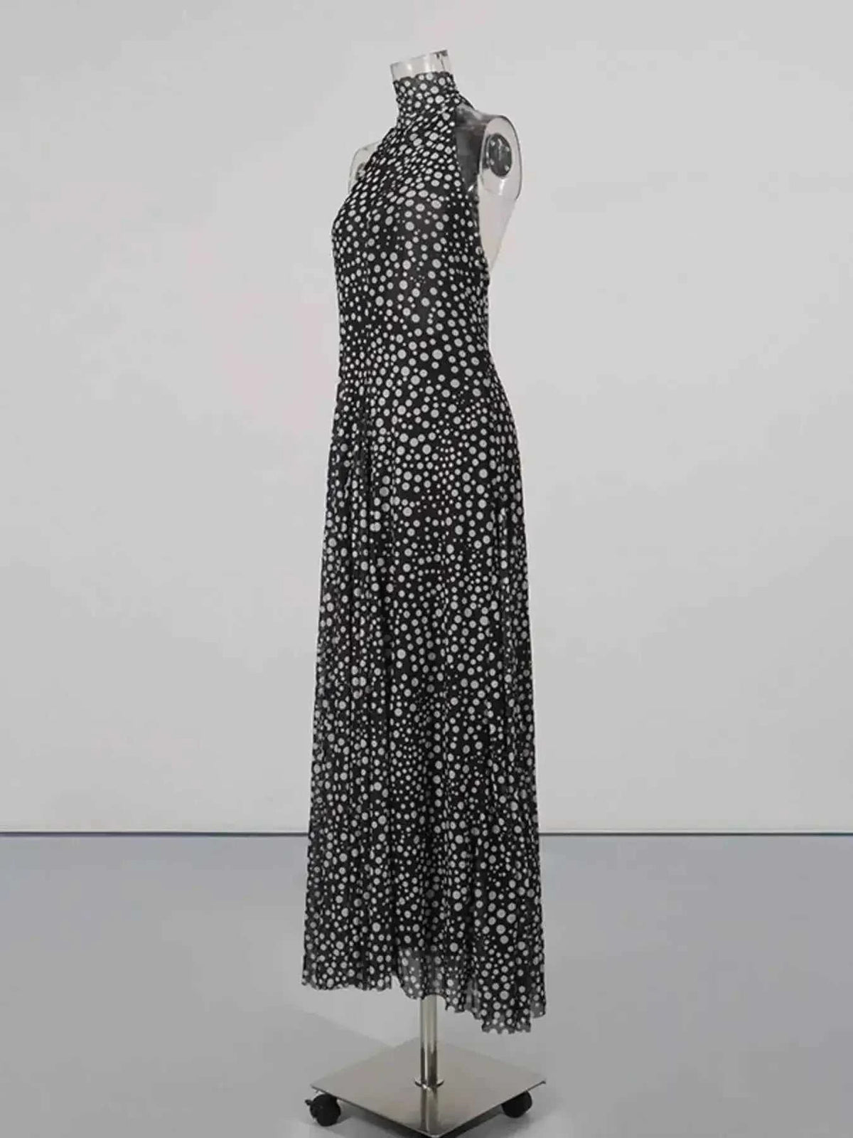 Halter Neck Polka Dot black maxi dress with white polka dots, halter neck, tied waist, and partially lined polyester fabric