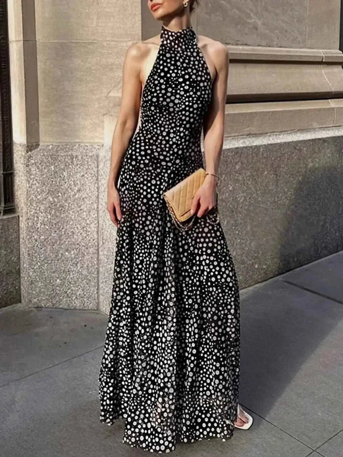 Halter Neck Polka Dot maxi dress in black with white polka dots, tied halter neck and flowy skirt