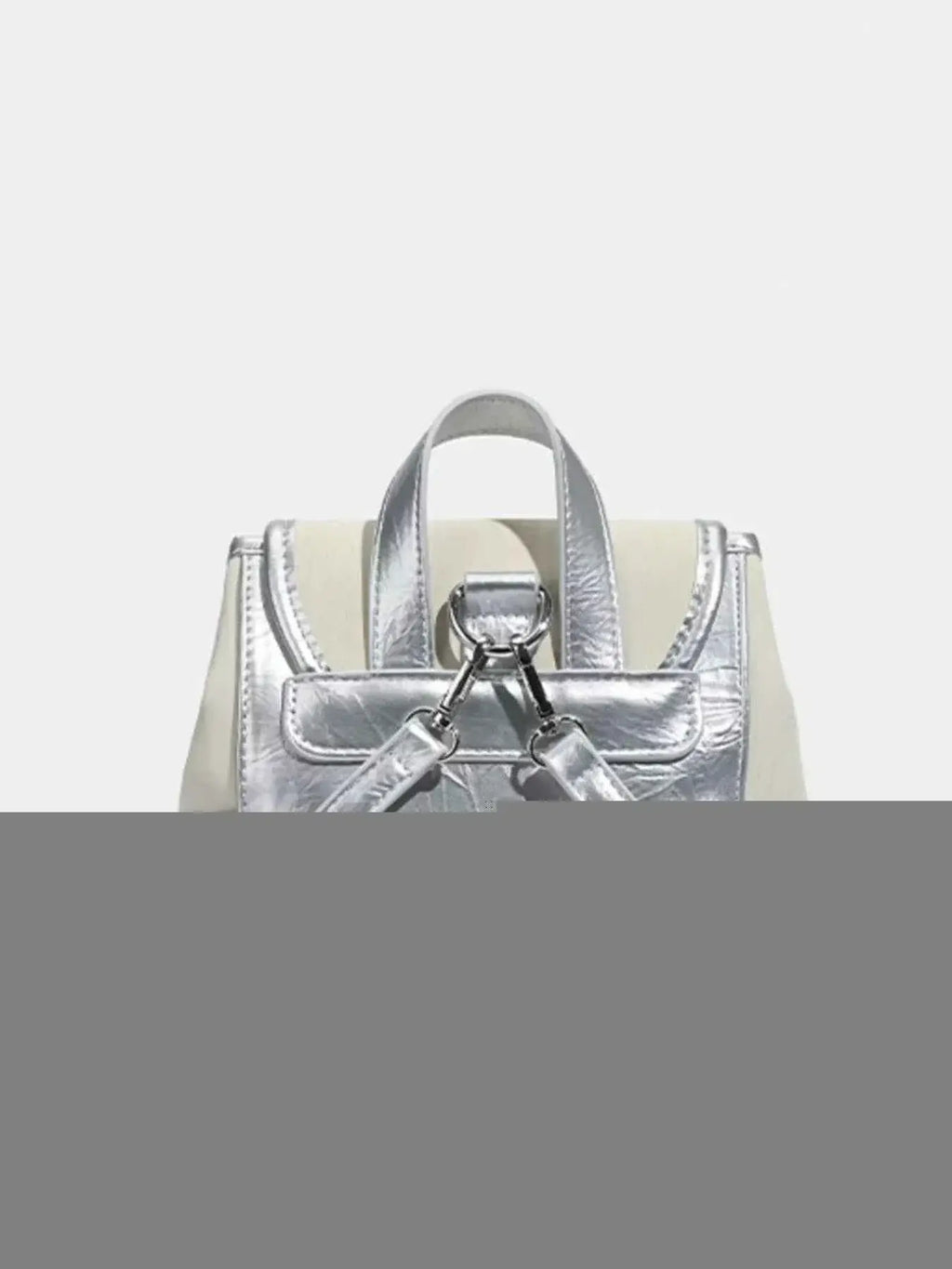 Mini Heart Flap Backpack in metallic silver PU leather with a small top handle and adjustable straps visible from the back