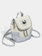 Mini Heart Flap Backpack in cream and silver PU leather with heart-shaped clasp and decorative chains on front flap